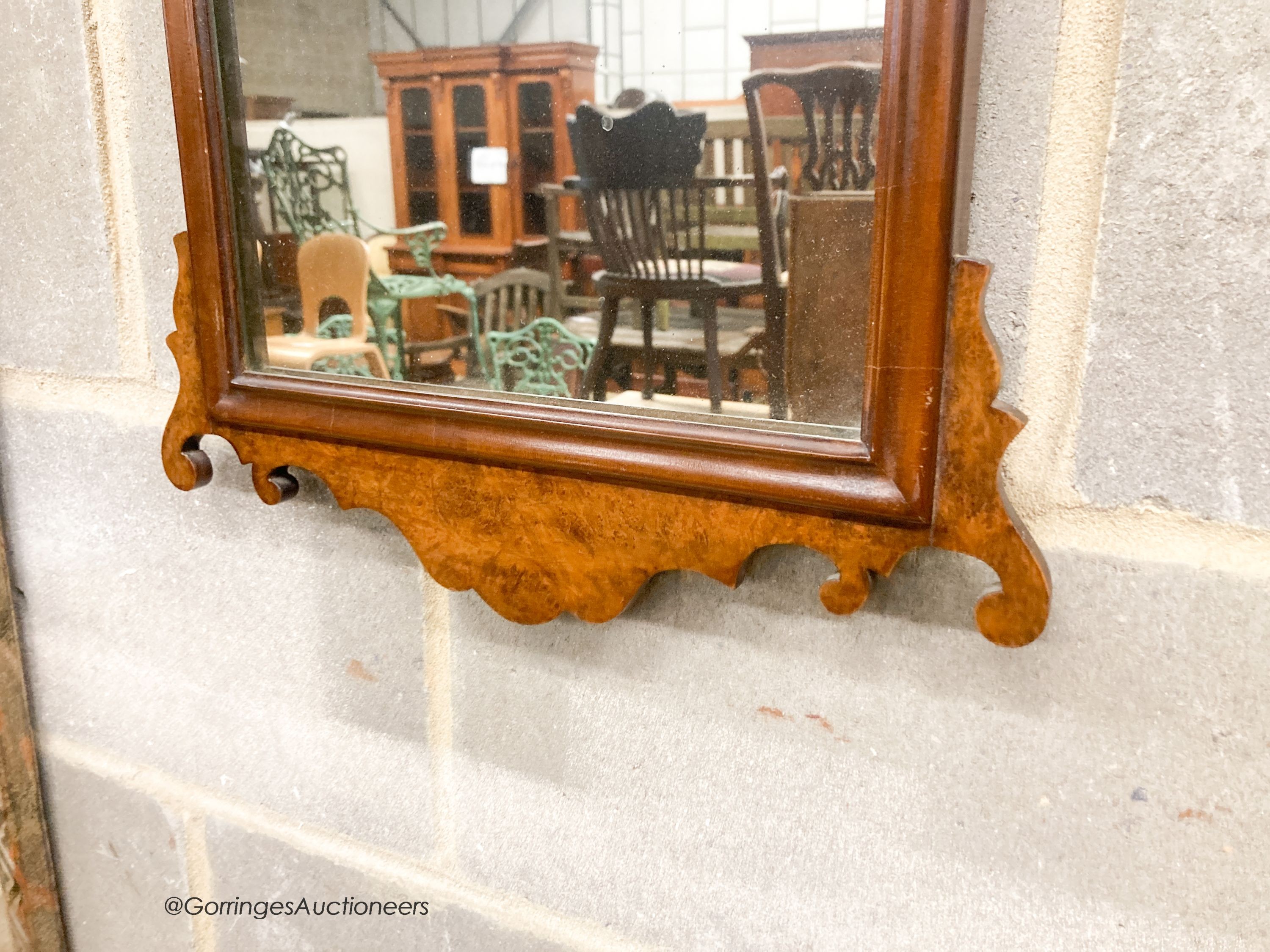 A pair of 18th century style walnut fret cut wall mirrors, width 42cm, height 70cm